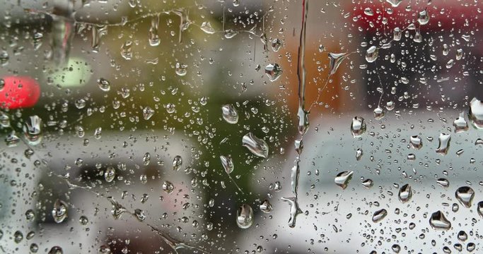 Looking out at the street through glass with raindrops