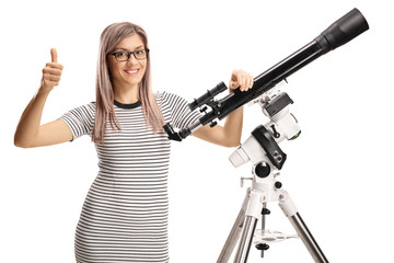 Young woman with a telescope giving thumbs up