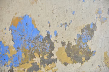 Photo sur Plexiglas Vieux mur texturé sale Beautiful colors layers of an outdoor plaster wall showing several times of wall repairing. Each color showing a new layer had been added to hide the old one below from time to time. 