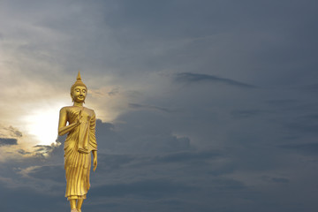 A superimposed or double exposures of Buddha image standing and sunset atmosphere full of the...