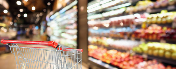 supermarket grocery store with fruit and vegetable shelves interior defocused background with empty...