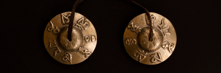 Singing Tibetan spiritual bells for mantra singing and meditation. Copper karatal on a leather...