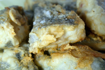 Slices of fish fried in batter close up Shallow depth of field