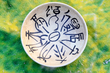 Fototapeta na wymiar Hieroglyphics on the ceramic bowl