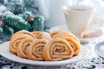 Biscuit festive roll with apple jam on a white bowl, horizontal