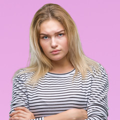 Naklejka premium Young caucasian woman over isolated background skeptic and nervous, disapproving expression on face with crossed arms. Negative person.