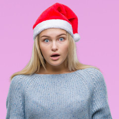 Young caucasian woman wearing christmas hat over isolated background afraid and shocked with surprise expression, fear and excited face.