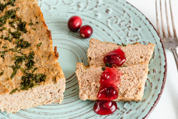 Chicken and liver pate with cranberry sauce, served on plate.