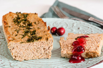 Chicken and liver pate with cranberry sauce, served on plate.