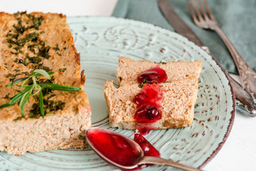 Chicken and liver pate with cranberry sauce, served on plate.