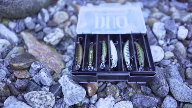 Fishing baits (hard baits) in a tackle box (slow motion pan shot)