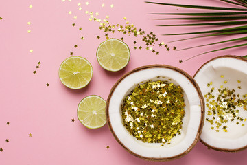 Coconut and palm with golden stars confetti on pink color paper background minimal style