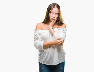 Young caucasian beautiful woman over isolated background thinking looking tired and bored with depression problems with crossed arms.