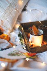 Christmas background dry oranges, sweet tangerines in a box, coffee in a white mug.