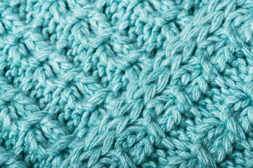 Mint knitted fabric texture closeup.  Can be used as a background. Selective focus
