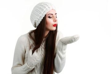 Smiling teenage girl wearing winter hat and gloves. Isolated