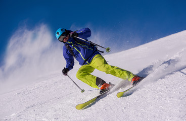 Skier having fun while running downhill