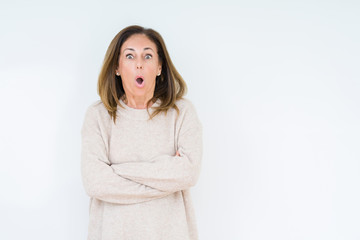 Beautiful middle age woman over isolated background afraid and shocked with surprise expression, fear and excited face.