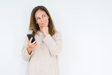 Middle age woman using smartphone over isolated background serious face thinking about question,...
