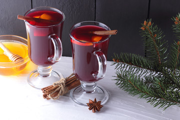 Mulled wine and Christmas tree branches on black and white background. Christmas mulled wine,...