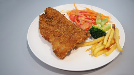 Fish Steak Dolly fritters with salad and french fried.