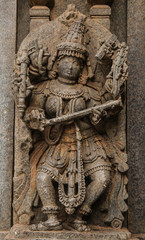 Fototapeta na wymiar Artistic stone sculptures and carvings of Hindu Gods & Goddesses at Somanathapura Temple in Karnataka, India. 