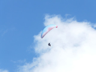 Gleitschirmflieger vor blauem Himmel oberhalb der österreichischen Kammspitze