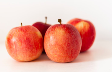 Ripe red apples on a table on a white background