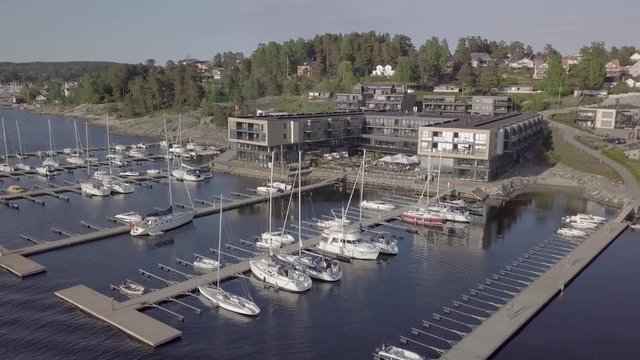 Slow panning drone shot around the harbor and Son Spa hotel outside Oslo, Norway.