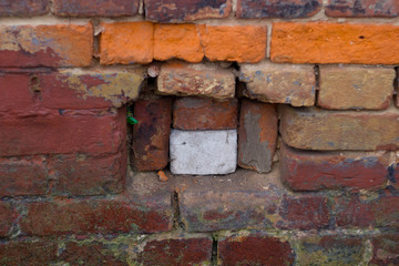Semi broken brick wall on the house. The background
