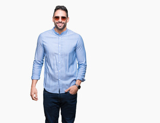 Fototapeta premium Young handsome man wearing sunglasses over isolated background with a happy and cool smile on face. Lucky person.