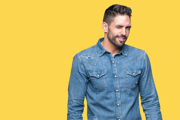 Young handsome man over isolated background winking looking at the camera with sexy expression,...