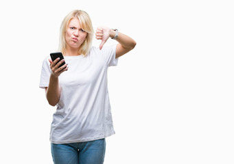 Fototapeta premium Young beautiful blonde woman using smartphone over isolated background with angry face, negative sign showing dislike with thumbs down, rejection concept
