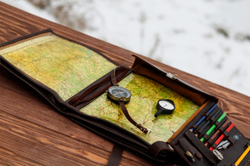 Winter is snowing. wooden table. There is a compass and odometer. there is toning