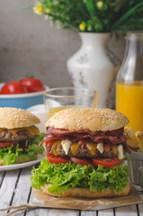 Homemade bacon burger with lettuce and cheddar
