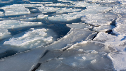 Frozen ice shoreline over the sea. Ice formations at the coast Sea of Japan.