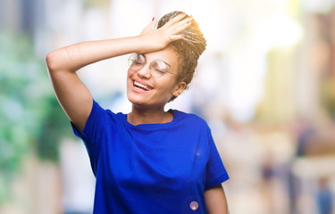 Young braided hair african american girl wearing glasses over isolated background surprised with...