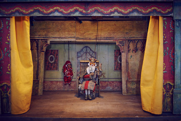 Handmade wooden puppet theater. King and Jester. Selective focus