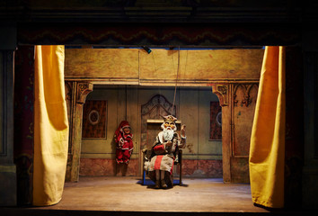 Handmade wooden puppet theater. King and Jester. Selective focus