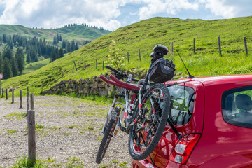 Mountainbike auf einem Heckgepäckträger eines roten autos