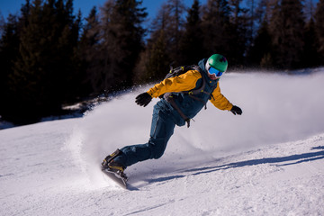 snowboarder running down the slope and ride free style