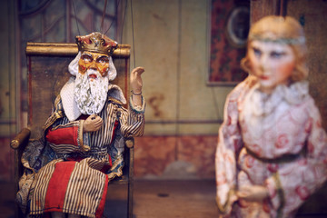 Handmade wooden puppet theater. King and princess. Selective focus