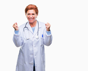 Senior caucasian doctor woman wearing medical uniform over isolated background celebrating surprised and amazed for success with arms raised and open eyes. Winner concept.