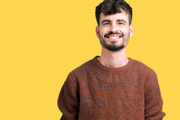 Young handsome man wearing winter sweater over isolated background with a happy and cool smile on face. Lucky person.