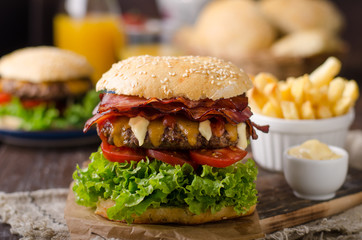 Homemade bacon burger with lettuce and cheddar
