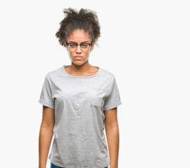 Fototapeta na wymiar Young afro american woman wearing glasses over isolated background skeptic and nervous, frowning upset because of problem. Negative person.