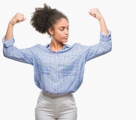 Young afro american woman over isolated background showing arms muscles smiling proud. Fitness concept.