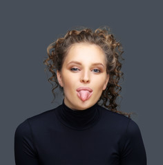 Portrait of attractive girl sticking out her tongue.