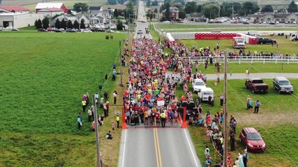 Aerial view, runners prepare for starting horn of 5k road race through Amish countryside in Bird-In-Hand, PA.