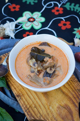 Vegetarian Tom Yum soup - Asian hot sour Thai food with mushrooms broth and lemongrass leaves in bowl. Vegan healthy food.